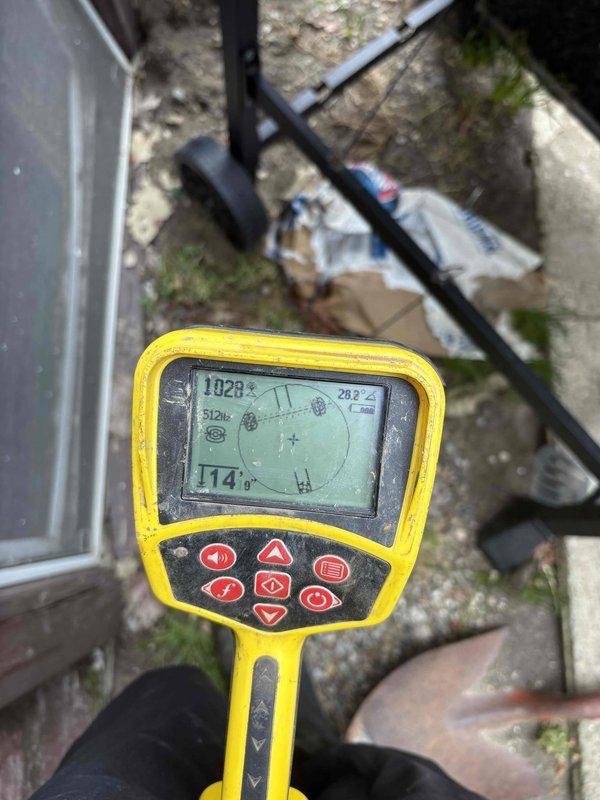 Successfully pumped out standing water from basement and attempted to clear floor drain with auger. Utilized detection equipment to identify drain location and documented significant concrete deterioration and corrosion around floor drain fixtures, which may indicate ongoing moisture issues requiring future attention.