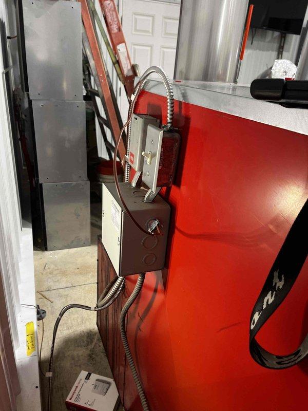 Successfully installed and connected thermostat to wood furnace located in barn structure. Completed electrical wiring from control box to thermostat, ensuring proper functionality for automated temperature control. System tested and confirmed operational.