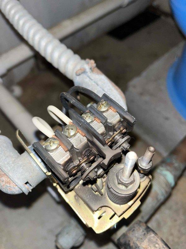 Responded to emergency no-water call and diagnosed failed well pump that was over 30 years old. Performed electrical testing with multimeter, measuring 238.3V AC at the contactor, and observed significant corrosion on the electrical terminals. Recommended complete replacement of the aging pump system due to extensive wear and terminal oxidation.