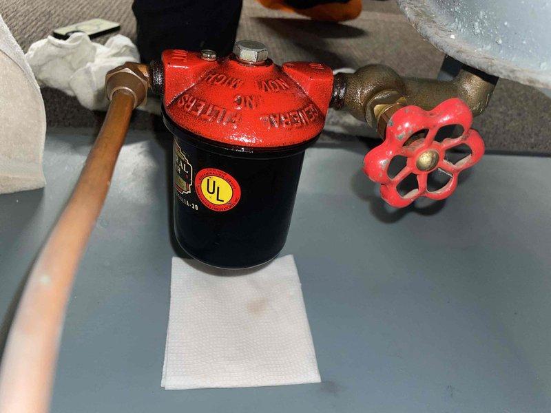 Diagnosed and serviced 7-year-old heat pump system that was not heating despite recent maintenance. Discovered contaminated fuel line requiring installation of new filter assembly with manual flow control valve. System now operating at optimal efficiency with clean fuel delivery.