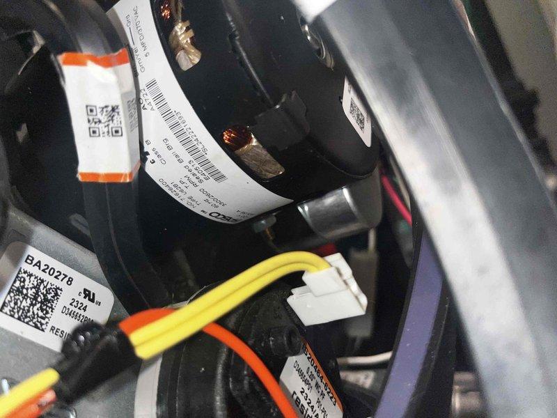 Performed routine heating maintenance on air handler unit under membership agreement. Inspected and documented motor assembly components with serial information and verified proper wire connections. Examined Emerson control board circuitry and digital display showing "E2L" code, confirming all wiring harnesses were secure and properly connected.