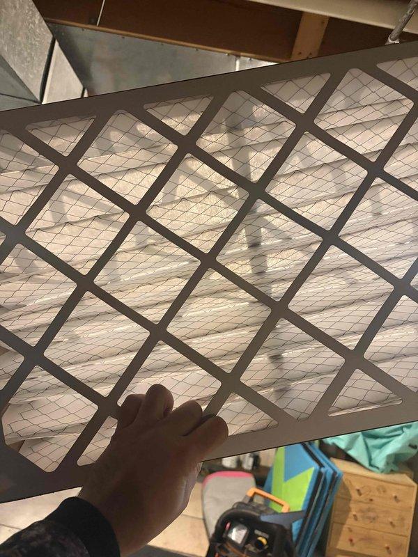 Responded to no heat call for furnace system blowing cold air. Inspected air filter and found it to be excessively clogged, restricting proper airflow. Replaced filter with new one, restoring normal system operation and resolving the heating issue.