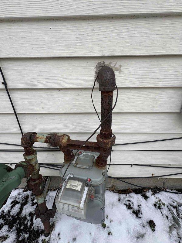 Conducted site assessment for new gas line installation to service pool heater. Observed existing meter setup with significant corrosion on iron pipes and connections. Need to confirm pool heater BTU requirements to properly size the new gas line and determine if system requires pounds configuration based on load requirements.