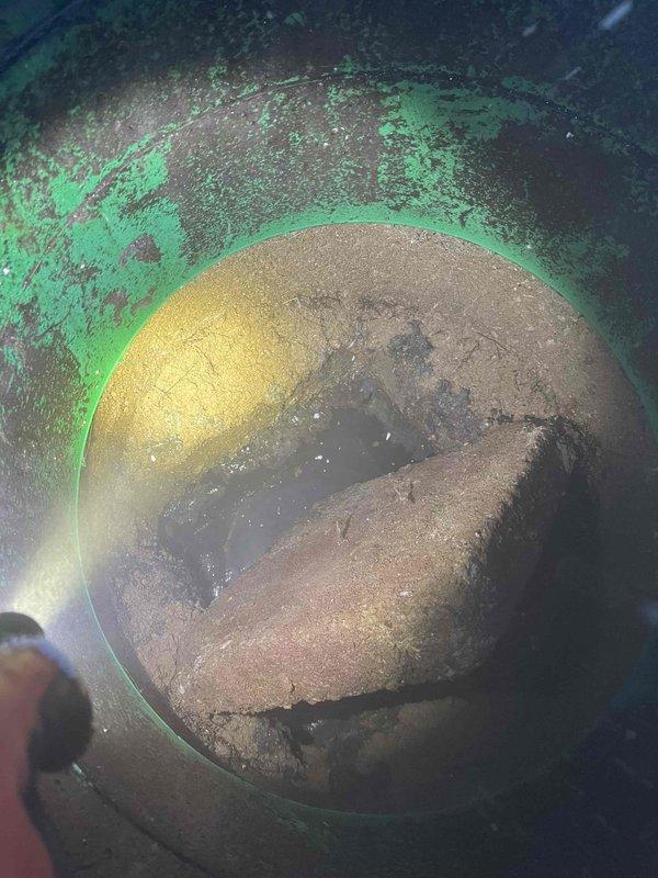 Responded to service call for main line blockage. Utilized power snake to clear significant mineral buildup and debris from drain pipe. Visual inspection revealed extensive corrosion in pipe interior with deteriorating walls and sediment accumulation, which was successfully removed to restore proper drainage function.