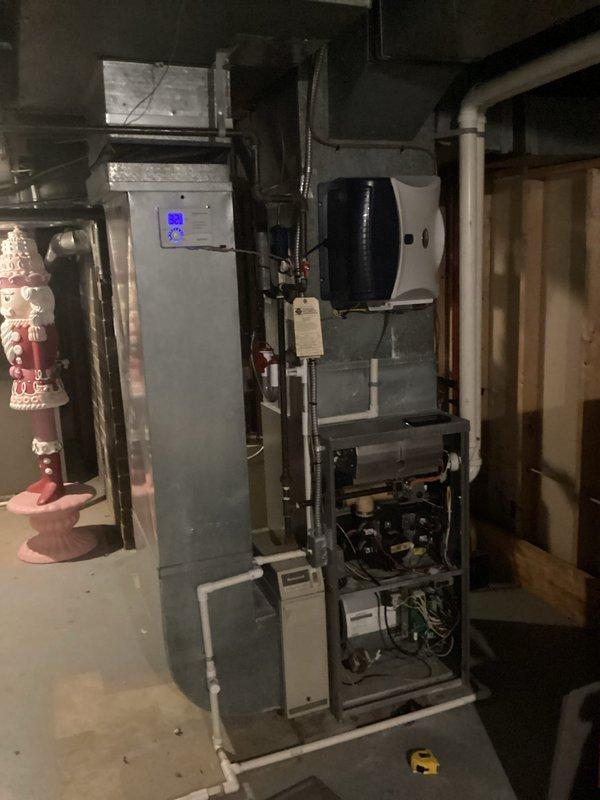 Conducted comprehensive evaluation of existing residential HVAC system located in basement, including detailed inspection of furnace components, associated ductwork, and attached humidifier unit. Documented current system condition through detailed photographs, noting potential replacement options for customer consideration based on lead referral.