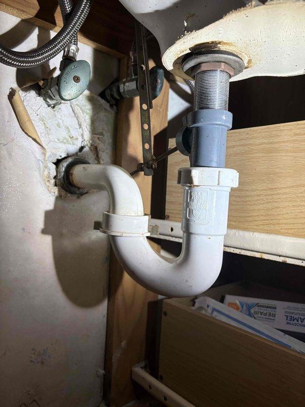 Successfully retrieved and returned a ring that had fallen into the kitchen sink drain by disassembling the P-trap assembly under the sink. Inspected all plumbing components after reassembly to ensure proper function and verify no leaks were present.