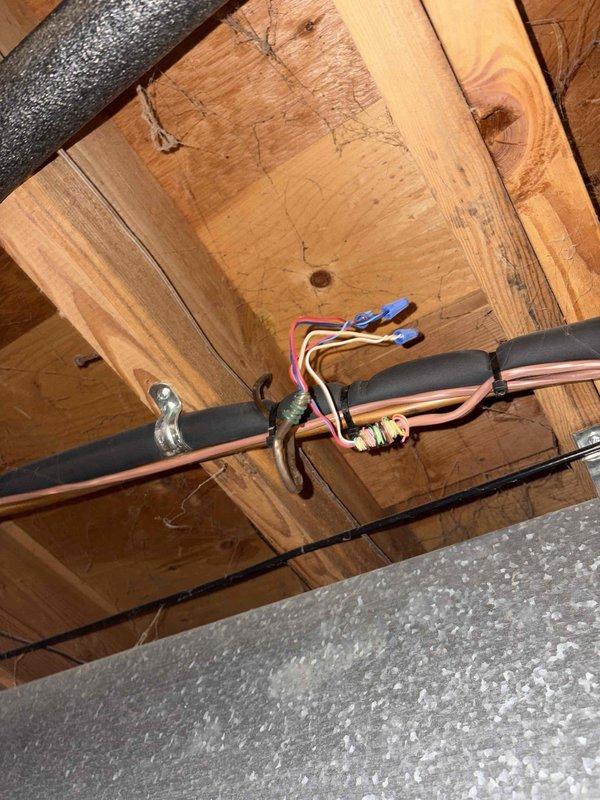 Performed heat pump maintenance service and inspected thermostat wiring for potential smart thermostat installation. Examined control board connections and existing wiring in ceiling/floor joist area, noting proper wire colors present for thermostat upgrade. Discussed maintenance plan options with customer who expressed interest in enrollment.