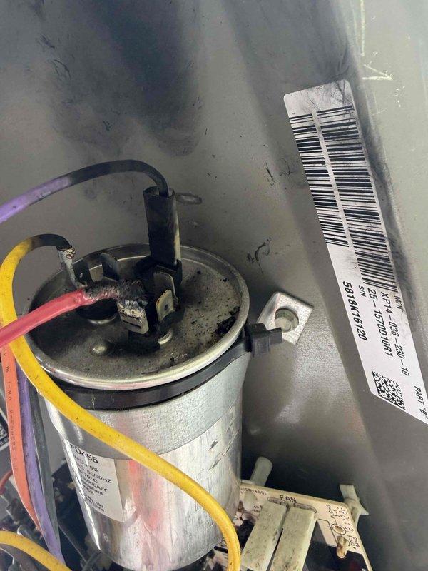 Diagnosed heat pump system showing "heat on" flashing indicator before power loss. Inspection revealed faulty capacitor (5mfd 440VAC) with visible discoloration affecting the air handler operation. Replaced capacitor, restoring proper system function and resolving the no-heat condition.