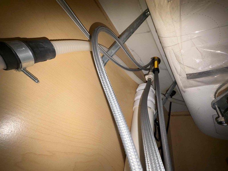 Completed return service call to replace customer-supplied kitchen faucet as previously sold. Successfully installed new brushed nickel pull-down faucet with proper connection of braided supply lines to existing plumbing. Verified proper operation of new fixture with no leaks at connection points.