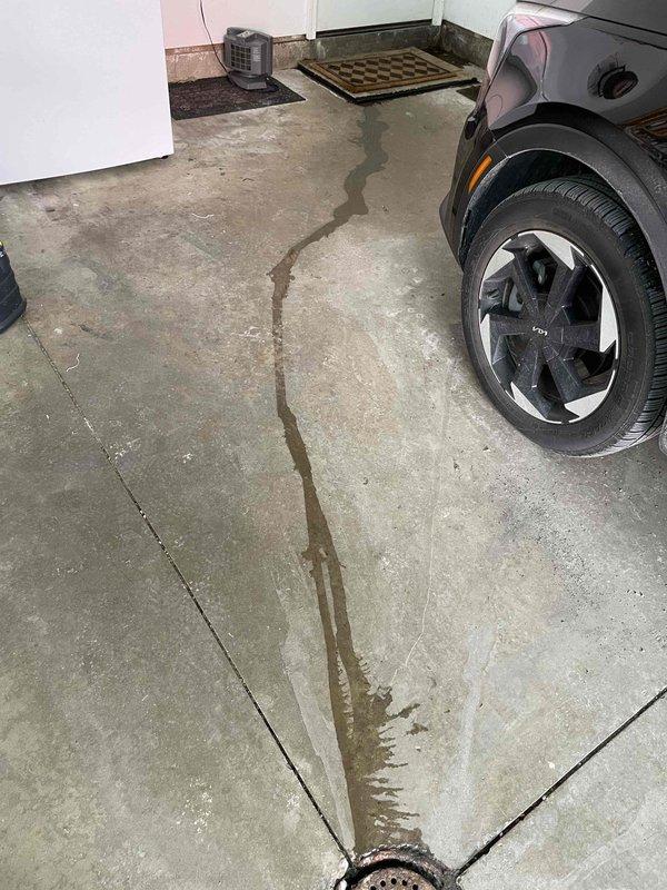 Replaced well pump pressure tank and installed new filter housings to address water treatment system issues. Identified and documented an active leak on the boiler in the concrete slab, evidenced by water staining on the garage floor trailing toward a drain. System now operating with proper pressure regulation and filtration.
