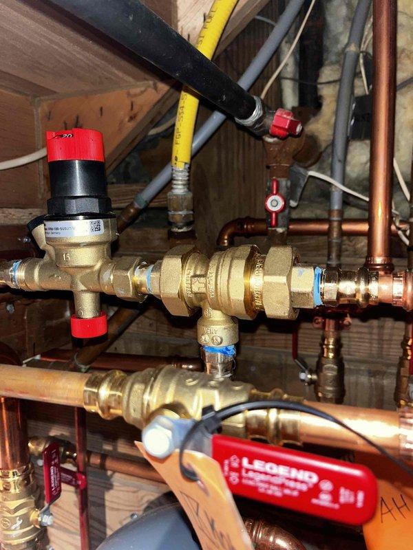 Responded to warranty service call for no heat condition. Inspected plumbing system with focus on backflow preventer assembly and associated copper piping. Examined gas line connections and multiple shut-off valves throughout the system. Verified proper installation of pressure regulator and control valves, ensuring all components were functioning correctly to restore heating operation.