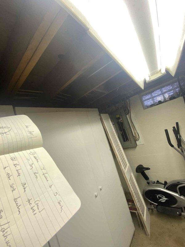 Conducted assessment for radiator relocation and replacement project in basement utility area. Took measurements of existing piping and floor space to determine feasibility of moving kitchen drain and water line for refrigerator DZ. Documentation includes photographs of utility room setup and precise measurements of installation area.