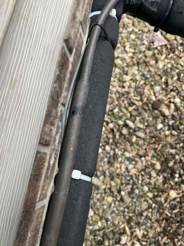 Conducted an inspection of existing HVAC system following a lead referral. Documented exterior refrigerant line insulation showing significant deterioration with exposed copper piping and improperly secured foam insulation. Interior inspection revealed inadequate equipment placement in a multi-purpose storage area with potential airflow restrictions and safety concerns.