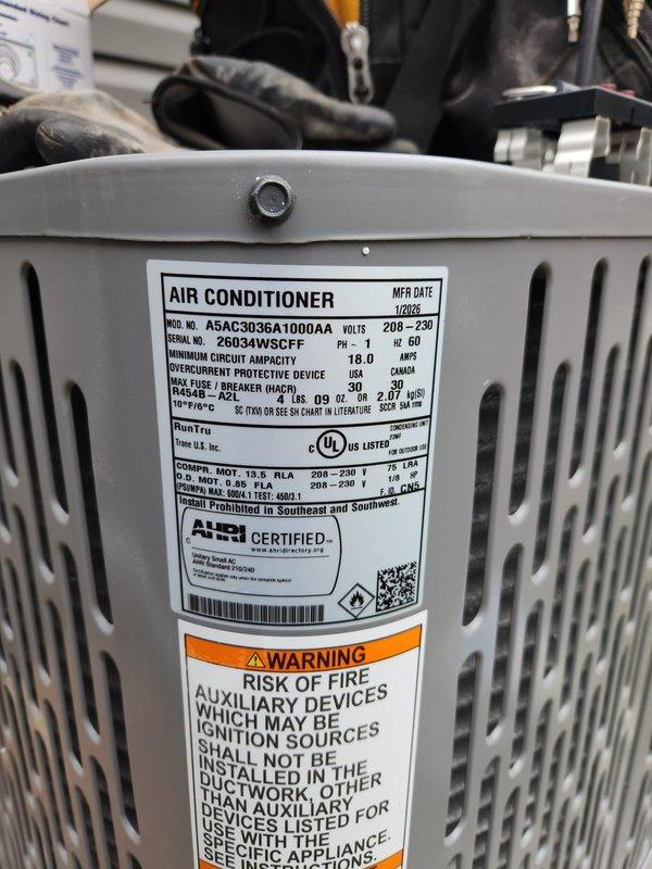 # HVAC Install - Complete System

## Job Description

Completed full HVAC system installation following approved project specifications. Installed new 3-ton air conditioning condenser unit (Model A5AC30036A1000AA) in exterior location with proper positioning and leveling verified by precision instruments. Unit was manufactured January 2023 and operates at 208-230 volts meeting all electrical specifications and safety requirements. Equipment was properly secured, labeled with all required technical specification and warning decals clearly visible, and positioned adjacent to building structure with adequate clearance from privacy fencing for optimal airflow and future maintenance access. All installation work performed in accordance with manufacturer guidelines and industry standards, with system ready for startup and commissioning.