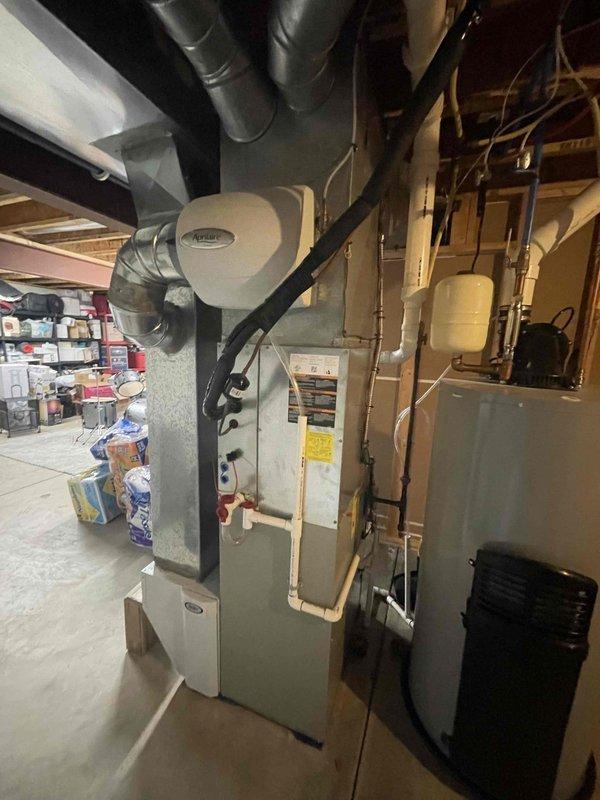 # HVAC Maintenance - Club Visit Summary

Completed heating system inspection and club membership enrollment for residential property. Customer enrolled in both HVAC and plumbing maintenance programs during this visit.

## Service Description

Performed comprehensive heating maintenance inspection on residential forced-air furnace system located in basement utility area. Conducted visual assessment of exterior furnace cabinet, ductwork connections, and surrounding mechanical equipment. Removed furnace access panel to inspect internal components including heat exchanger assembly, blower motor, electrical wiring harnesses, control board, and gas connections.

Examined heat exchanger for signs of cracks, corrosion, or deterioration. Inspected blower motor assembly and verified proper mounting and electrical connections. Reviewed control board for any visible signs of damage, burnt components, or loose connections. Assessed wiring throughout unit, noting multiple color-coded wire runs conne