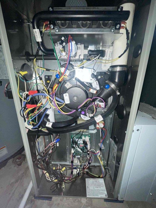 # HVAC Maintenance - Club Visit Summary

Completed heating system inspection and club membership enrollment for residential property. Customer enrolled in both HVAC and plumbing maintenance programs during this visit.

## Service Description

Performed comprehensive heating maintenance inspection on residential forced-air furnace system located in basement utility area. Conducted visual assessment of exterior furnace cabinet, ductwork connections, and surrounding mechanical equipment. Removed furnace access panel to inspect internal components including heat exchanger assembly, blower motor, electrical wiring harnesses, control board, and gas connections.

Examined heat exchanger for signs of cracks, corrosion, or deterioration. Inspected blower motor assembly and verified proper mounting and electrical connections. Reviewed control board for any visible signs of damage, burnt components, or loose connections. Assessed wiring throughout unit, noting multiple color-coded wire runs conne