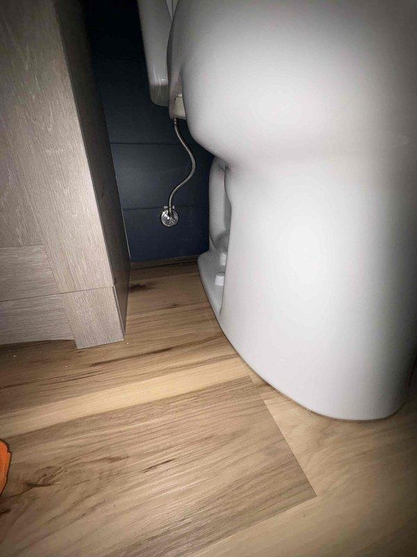 # Plumbing Service - Sold Repair Summary

Returned to property to complete follow-up work on previously sold plumbing repair. Installed new toilet flange assembly with wax ring seal and secured mounting hardware to establish proper connection between toilet fixture and drain pipe. Verified water heater installation and associated supply line connections in utility area remain secure and operational.