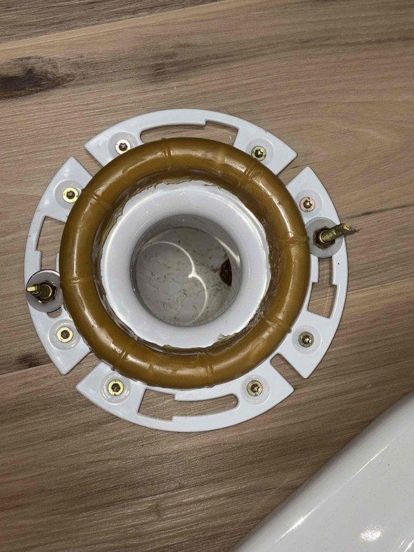 # Plumbing Service - Sold Repair Summary

Returned to property to complete follow-up work on previously sold plumbing repair. Installed new toilet flange assembly with wax ring seal and secured mounting hardware to establish proper connection between toilet fixture and drain pipe. Verified water heater installation and associated supply line connections in utility area remain secure and operational.