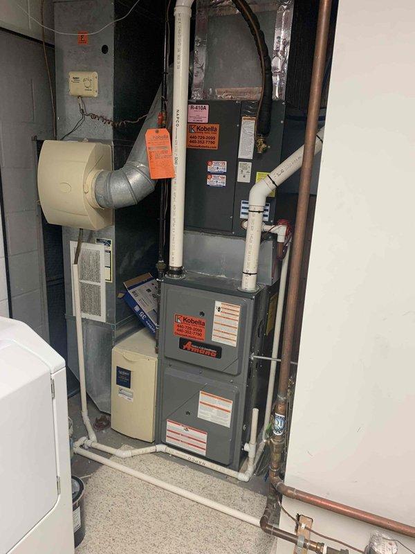 # Service Report

## Summary
Responded to customer report of loud bang, system shutdown with intermittent operation, and beeping alarm. Performed diagnostic inspection of furnace system and identified inducer motor assembly with significant corrosion on mounting bracket and base plate requiring immediate attention for safe operation.

## Work Performed

Upon arrival, conducted comprehensive safety inspection of furnace system in response to reported loud bang and subsequent operational irregularities. Performed visual and operational assessment of all major components including heat exchanger, blower assembly, control board, and venting system.

Inspected furnace cabinet and identified Kobelco-branded unit with connected humidifier system and PVC venting. Verified proper electrical connections at wall-mounted control box and traced all wiring for signs of arcing or damage that could explain reported noise and system behavior.

Focused investigation on inducer motor assembly after notin