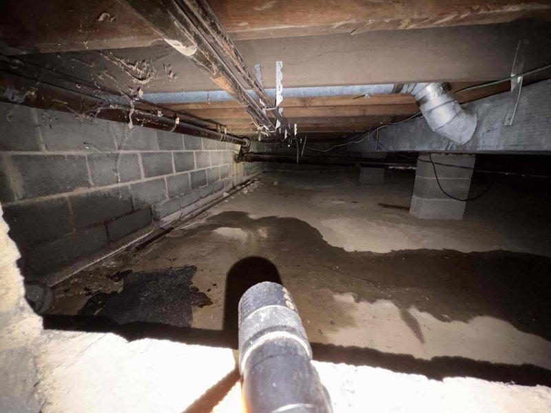 # Service Report: Plumbing Service - Clogged Drain/Sink

Responded to drainage issue in garage of 70-year-old residential property. Upon arrival, conducted comprehensive assessment of plumbing system including the reported drain problem and secondary toilet concern. Accessed crawl space beneath structure to inspect drainage lines and plumbing infrastructure. Inspection revealed aging plumbing system consistent with home's age, with evidence of moisture accumulation on vapor barrier in crawl space. Examined PVC drainage pipes, foundation plumbing penetrations, and overall condition of accessible plumbing components. Additionally evaluated toilet fill valve mechanism which was not achieving proper water level after flush cycle. Documented conditions via photographs for service records. Provided recommendations for addressing identified issues to restore proper drainage function and toilet operation.