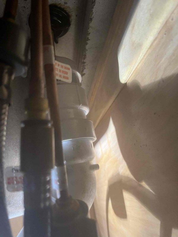 # Job Summary

Responded to service call for clogged kitchen sink with no other drains affected in the residence.

# Work Performed

Upon arrival, assessed the kitchen sink drainage system and confirmed blockage was isolated to the kitchen sink only. Inspected the P-trap assembly and drainage piping beneath the sink cabinet. Disassembled the white PVC P-trap configuration to access and clear the obstruction. Removed accumulated debris and buildup causing the blockage from the trap and drain line. Cleaned all trap components thoroughly and inspected pipe fittings and coupling nuts for proper condition. Reassembled the P-trap assembly, ensuring all threaded connections were properly tightened and sealed. Tested the drain system by running water through the sink to verify proper flow and drainage. Confirmed no leaks were present at any connection points. Inspected adjacent plumbing components including water supply lines and shut-off valves to ensure overall system integrity. Left work ar