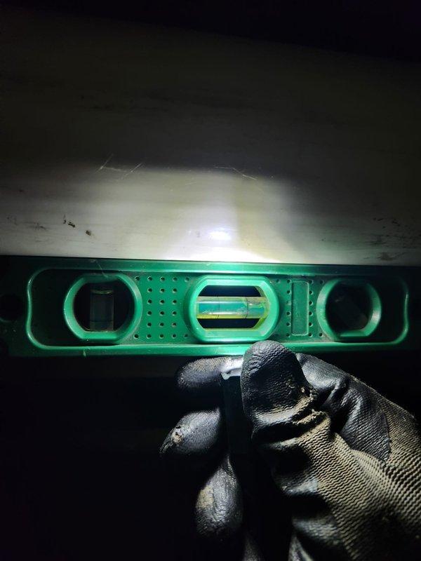 Replaced 3-inch exhaust flue pipe extending up to 30 feet in length. Installation required working in confined crawlspace area with exposed joists and existing plumbing infrastructure, utilizing hammer drill and level to ensure proper pitch and secure mounting of new flue pipe components.