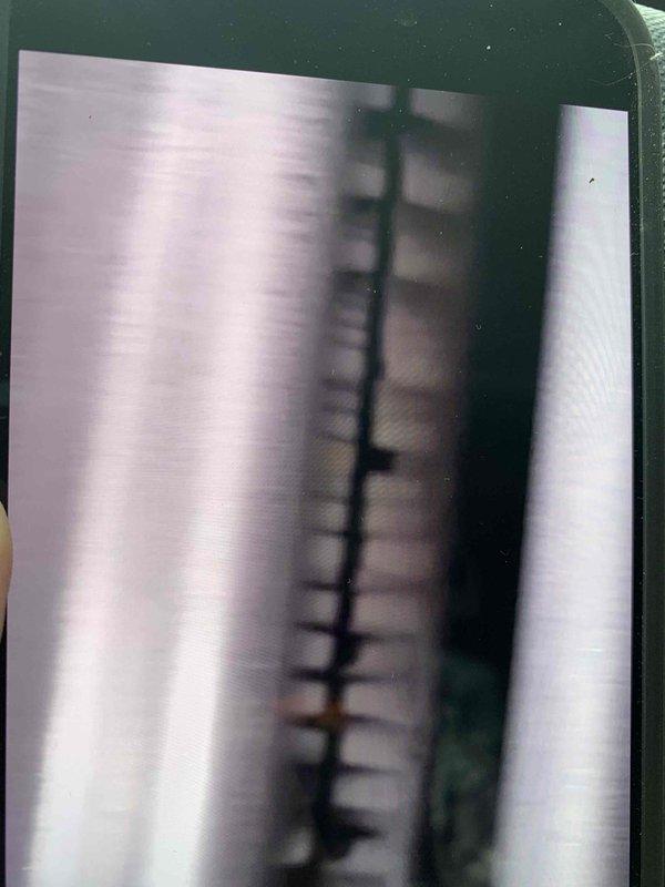 Responded to service call for 10-year-old boiler producing percolating noise. Performed comprehensive tune-up and maintenance service on residential boiler system. Conducted visual inspection of boiler unit, expansion tank, associated piping, and connections in basement mechanical room. Evaluated system operation and assessed noise complaint. Completed standard maintenance procedures including system flush to address sediment buildup causing percolating sounds. Verified proper operation of water heater and HVAC equipment in utility area. Documented equipment condition with photographs showing green boiler unit, expansion tank mounting, copper piping configuration, and overall mechanical room layout. System restored to normal operating parameters with noise issue resolved.