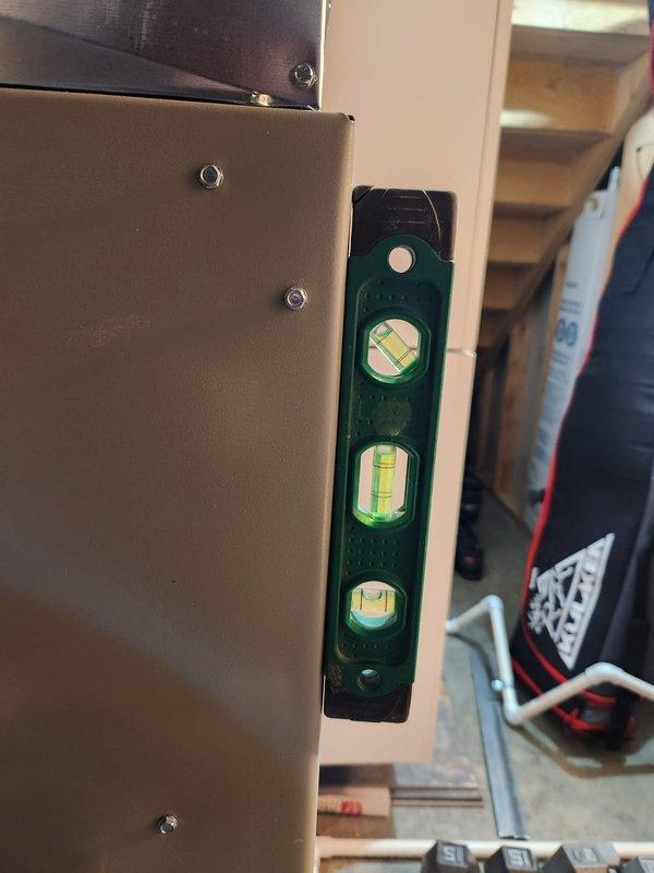 Completed furnace installation with American Standard system and integrated indoor sensor positioned in first floor living room area off kitchen. Verified proper leveling and alignment of equipment cabinet and ductwork connections using precision measurement tools. Installed and programmed wall-mounted digital thermostat control, confirmed operational status, and left additional filter media on-site for customer use.