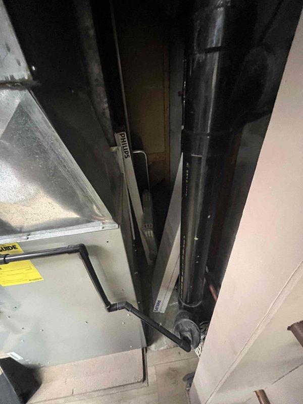 Completed HVAC system evaluation for 18-year-old furnace with non-operational blower motor and draft inducer issues. Existing air conditioning system assessed and determined to be in satisfactory working condition. Documented equipment condition and mechanical room configuration, including air handler unit, refrigerant line routing, and ceiling-mounted HVAC components. Provided replacement estimate for furnace system while confirming AC unit does not require replacement at this time.