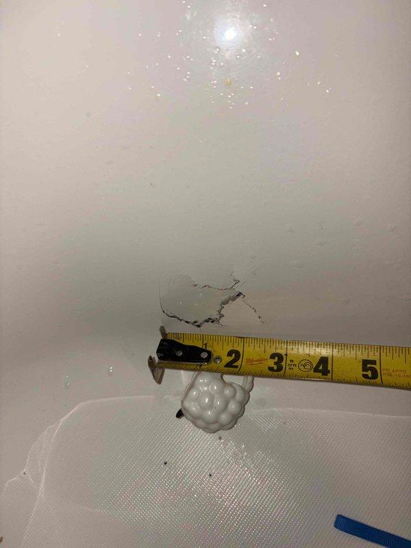 Responded to emergency call for active water leak with steady flow threatening electrical panel in twenty-year-old residential property. Located and assessed two separate leak points causing water intrusion along interior wall surfaces with visible damage and moisture penetration near doorway trim and molding. Documented extent of water damage including wall cracking, discoloration, and active moisture present on painted surfaces. Mitigated immediate safety hazard by stopping water flow to prevent further damage to electrical components and building structure.