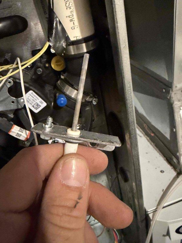 Completed heating maintenance club visit on residential HVAC system. Inspected and evaluated flame sensor rod for proper operation and positioning within the burner assembly. Performed combustion analysis and pressure diagnostics using dual-port manometer, recording inlet and outlet pressures at 83.5 and 83.6 respectively to verify proper gas valve and manifold operation.