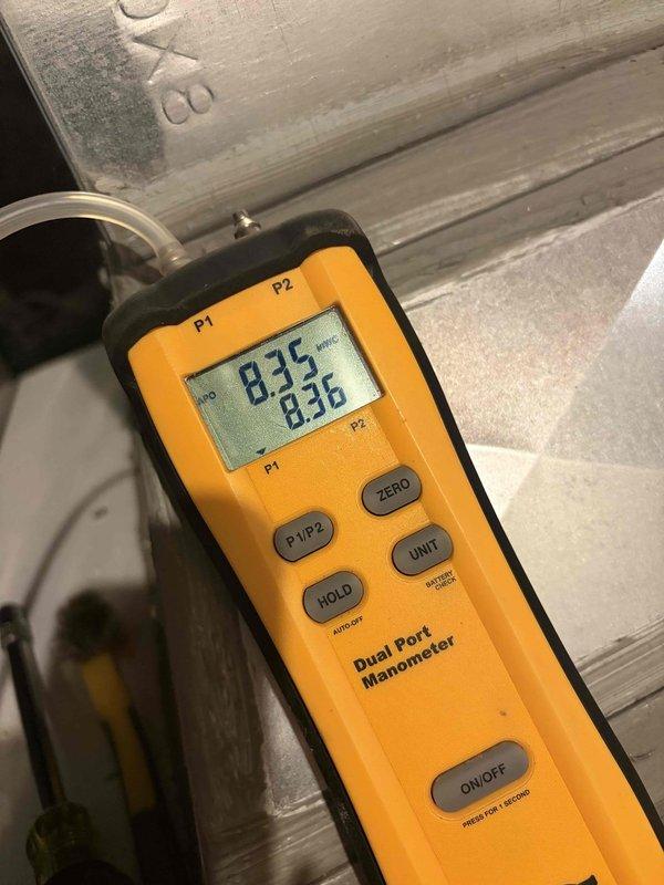 Completed heating maintenance club visit on residential HVAC system. Inspected and evaluated flame sensor rod for proper operation and positioning within the burner assembly. Performed combustion analysis and pressure diagnostics using dual-port manometer, recording inlet and outlet pressures at 83.5 and 83.6 respectively to verify proper gas valve and manifold operation.