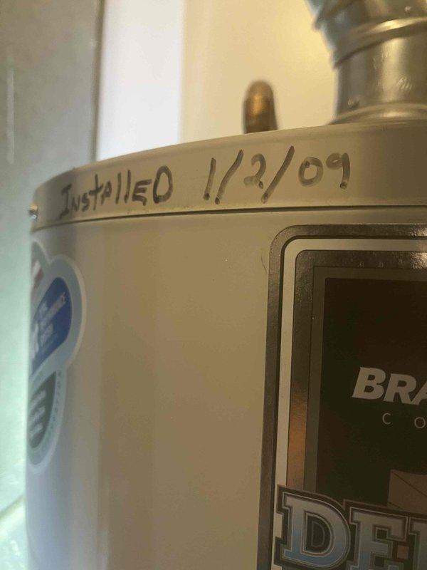 Performed comprehensive assessment of 17-year-old residential water heater unit originally installed in 2009. Documentation revealed significant age-related deterioration with visible corrosion and mineral deposit accumulation at pipe penetration points, indicating potential leak concerns. Provided detailed estimate for complete water heater replacement, including photographic documentation of existing unit condition and corrosion damage to support recommendation for immediate replacement due to equipment exceeding typical service life expectancy.