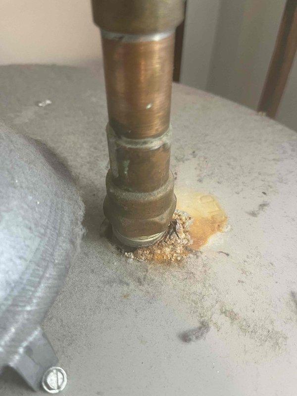 Performed comprehensive assessment of 17-year-old residential water heater unit originally installed in 2009. Documentation revealed significant age-related deterioration with visible corrosion and mineral deposit accumulation at pipe penetration points, indicating potential leak concerns. Provided detailed estimate for complete water heater replacement, including photographic documentation of existing unit condition and corrosion damage to support recommendation for immediate replacement due to equipment exceeding typical service life expectancy.