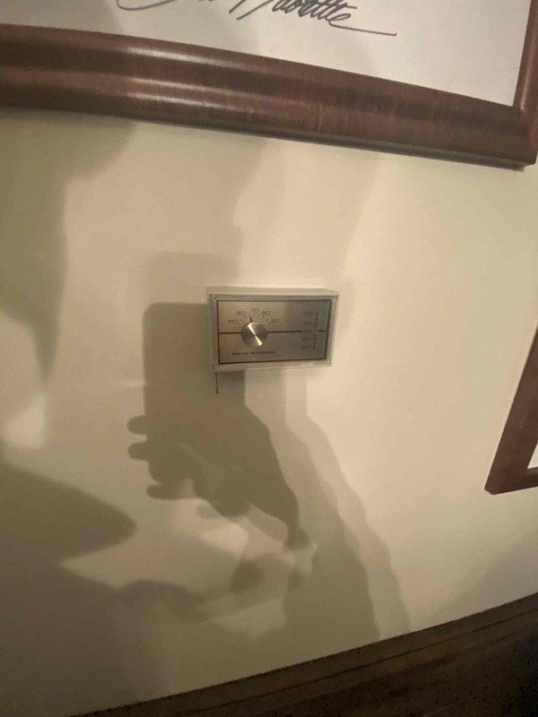 Performed on-site evaluation of existing oil-fired boiler system for conversion to electric air handler. Assessed current mechanical installation including boiler unit, copper piping distribution, control valves, and electrical infrastructure. Documented existing equipment configuration with multiple pipe connections, brass fittings, and electrical conduit routing to panel box. Evaluated wall-mounted components and system layout to determine requirements for electric heating conversion. Provided estimate for removal of oil boiler system and installation of electric air handler unit.