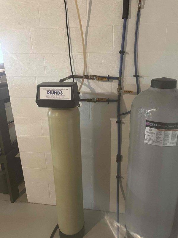 Serviced dual-tank water treatment system consisting of an iron, manganese, and sulfur filtration unit with electronic control valve. Inspected media condition in filter tank and verified system operation, discussing with property owner the recommended media replacement interval of approximately five years for optimal filtration performance.