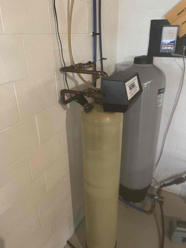 Serviced dual-tank water treatment system consisting of an iron, manganese, and sulfur filtration unit with electronic control valve. Inspected media condition in filter tank and verified system operation, discussing with property owner the recommended media replacement interval of approximately five years for optimal filtration performance.