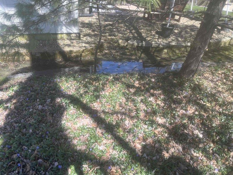 Conducted site assessment for residential drainage issues caused by improperly discharged downspouts and elevated adjacent properties creating water accumulation in yard. Evaluated existing conditions including downspout splash blocks located approximately 100 feet from storm drain connection point and saturated soil conditions affecting both sides of property. Provided estimate for installation of French drain system to redirect surface water to existing storm drain, along with underground piping to connect downspouts directly to drainage infrastructure, eliminating splash-out and improving overall yard drainage.