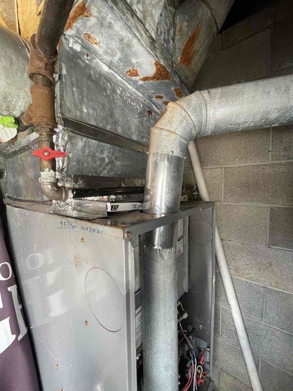 Responded to no heat call on 3-year-old furnace system. Upon arrival, discovered significant frost and ice accumulation on refrigerant lines and pipe fittings inside the unit, indicating abnormal operating conditions. Observed aged and corroded ductwork with rust spots throughout the plenum and galvanized steel components. Attempted to contact customer regarding service appointment but was unable to confirm booking. Left voicemail message for customer callback to schedule proper diagnostic service and repair of heating system malfunction.