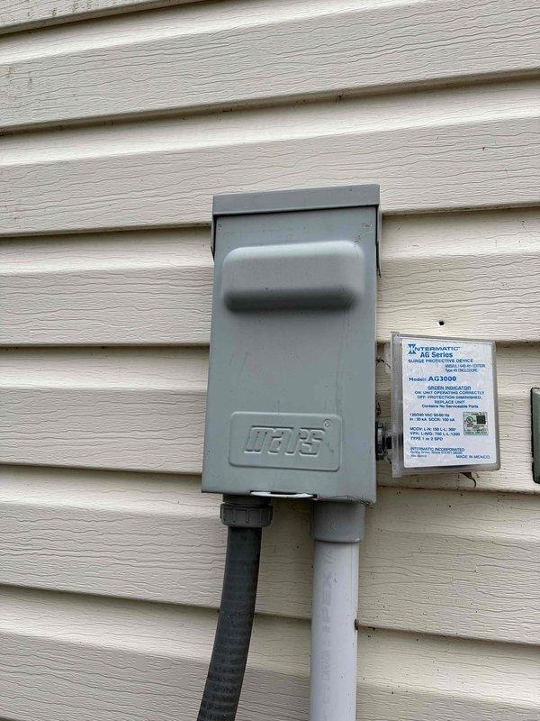 Completed cooling maintenance club visit on air handler system. Performed comprehensive inspection of electrical components including disconnect box and control systems, verified proper voltage readings at 234V using calibrated testing equipment, and documented equipment specifications including Intermatic AG2403C surge protection device. All systems operating within normal parameters with no deficiencies noted.