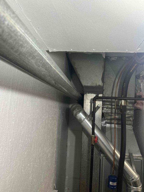 Conducted on-site evaluation of existing conventional tank-style gas water heater with atmospheric venting to provide estimate for tankless water heater conversion. Assessed current utility closet configuration, existing gas supply line capacity, venting infrastructure including PVC exhaust system, electrical requirements, and available clearances for tankless unit installation. Documented existing plumbing connections, copper supply lines, shut-off valves, and temperature controls to determine necessary modifications for tankless system integration.