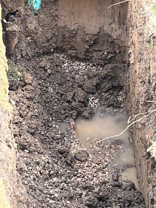 Completed excavation and water line repair in residential backyard. Coordinated with Painesville City Water Distribution for water shutoff at 9am and arranged for inspection upon completion. Excavated trench to required depth following OUPS locate request 2608501430-000, utilizing hand digging methods within the statutory tolerance zone due to proximity to AT&T high profile facility. Installed new turquoise PVC water service line with proper fittings and cap. Work performed in accordance with utility marking requirements and safety protocols for underground facilities.