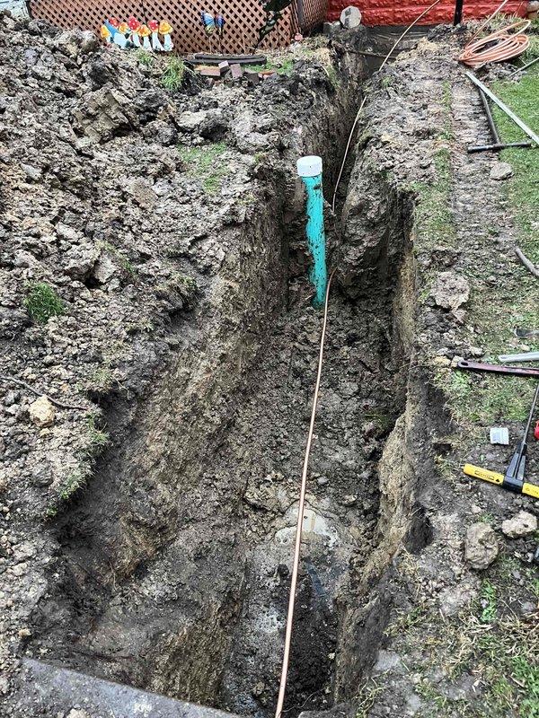 Completed excavation and water line repair in residential backyard. Coordinated with Painesville City Water Distribution for water shutoff at 9am and arranged for inspection upon completion. Excavated trench to required depth following OUPS locate request 2608501430-000, utilizing hand digging methods within the statutory tolerance zone due to proximity to AT&T high profile facility. Installed new turquoise PVC water service line with proper fittings and cap. Work performed in accordance with utility marking requirements and safety protocols for underground facilities.