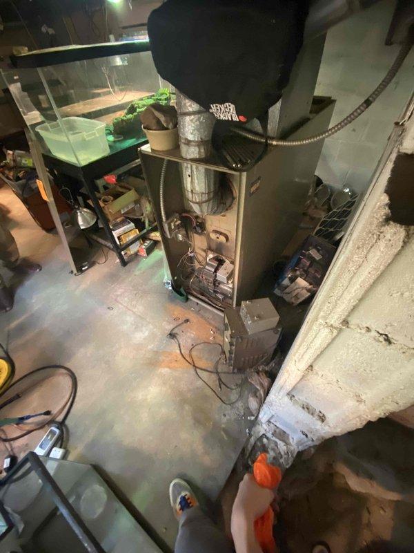 Completed HVAC estimate for replacement of flood-damaged Magic Chef oil furnace and existing air conditioning system in basement utility area. Equipment assessment confirmed both heating and cooling systems were compromised by water damage and required full replacement due to age and operational failure.