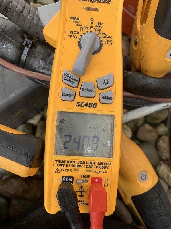 Completed cooling maintenance club visit on air handler unit. Inspected electrical components including dual Edison ECNR25 fuses in holder, verified proper connections and wiring integrity. Measured system amperage at 24.00 amps using clamp meter, confirming unit operating within normal parameters. All components functioning properly with no issues identified.