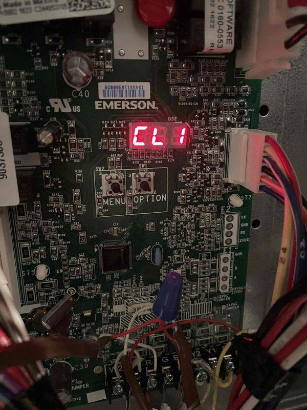 Completed routine cooling maintenance member visit on air handler system. Inspected Emerson control board displaying Et1 error code and verified system operation. Checked refrigerant pressures using manifold gauges, recording 874 PSIG suction and 2672 PSIG discharge with superheat of 2.15°F and subcooling of 9.17°F, confirming proper refrigerant charge and system performance.