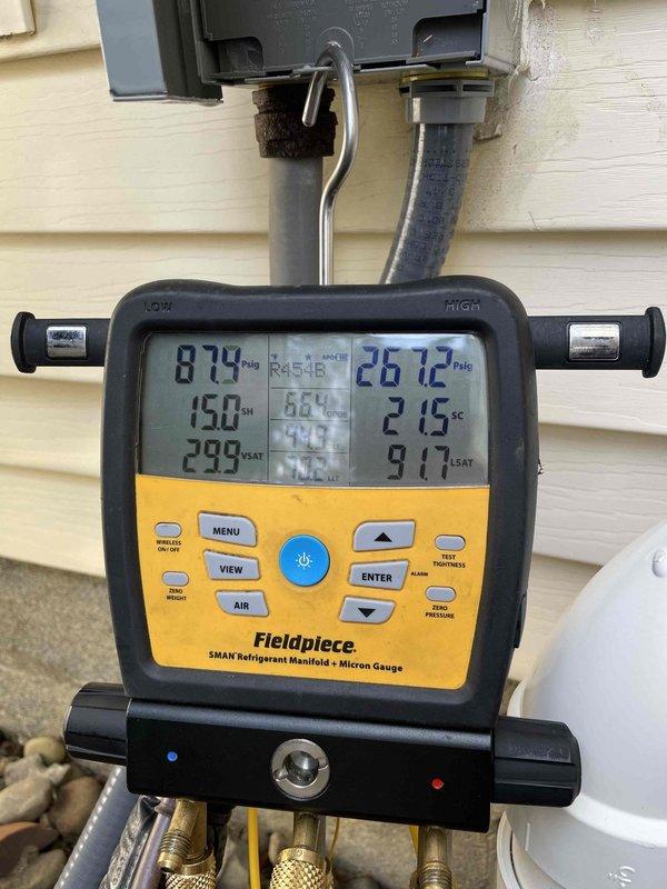 Completed routine cooling maintenance member visit on air handler system. Inspected Emerson control board displaying Et1 error code and verified system operation. Checked refrigerant pressures using manifold gauges, recording 874 PSIG suction and 2672 PSIG discharge with superheat of 2.15°F and subcooling of 9.17°F, confirming proper refrigerant charge and system performance.