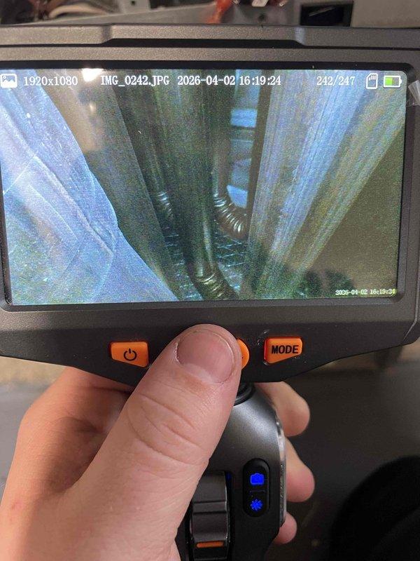 Responded to complaint of furnace blowing cold air. Performed diagnostic inspection using borescope camera to examine heat exchanger and internal ductwork components. Inspection revealed disconnected or improperly routed flexible duct connections within the system, preventing heated air from properly circulating through the supply plenum. Documented findings with inspection camera showing flexible ductwork and heat exchanger condition for service records.