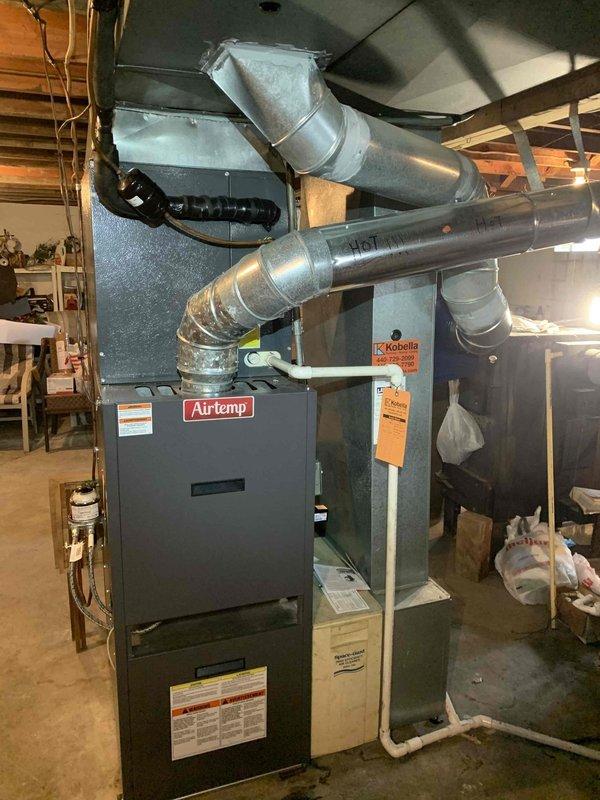 Installed Model 620 water-efficient bypass humidifier on existing Airtemp furnace system in basement utility area. Connected humidifier to supply plenum with appropriately sized ductwork, established water supply line connection, and integrated humidistat control with furnace operation. Verified proper airflow through bypass configuration, tested water flow and drainage, and confirmed system cycling operates correctly with heating system.