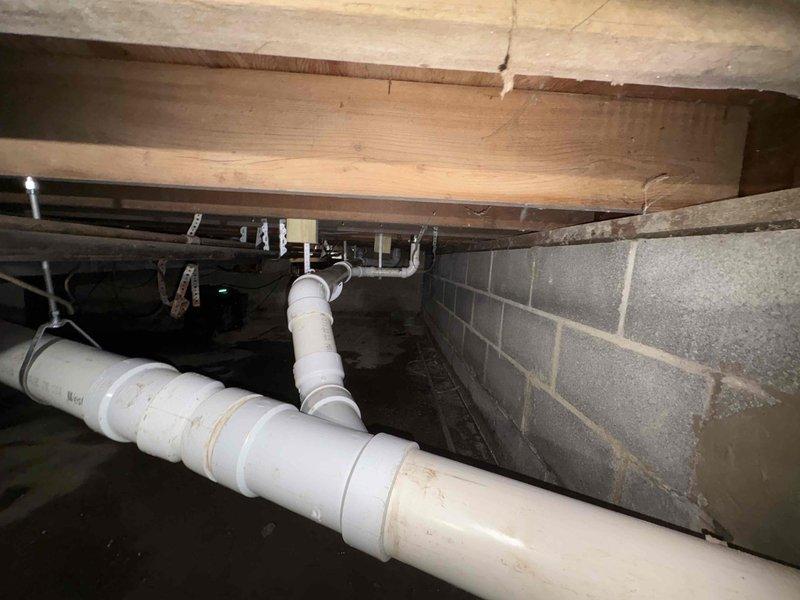 Completed first phase of sanitary line repipe project in crawlspace, replacing outdated piping with PVC throughout the system. Repiped toilet line for living room toilet into main sanitary line and installed new exterior cleanout for improved access and maintenance. Updated all remaining sanitary piping to PVC code-compliant materials. Excavation and underground repipe work completed as scheduled, with second phase to follow after flooring installation to complete hall bathroom toilet replacement and flange inspection/replacement.